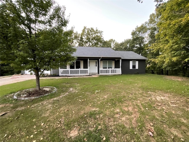 ranch-style house featuring a porch and a front lawn