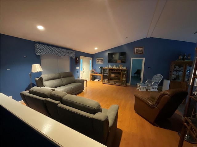 living room featuring vaulted ceiling and hardwood / wood-style flooring