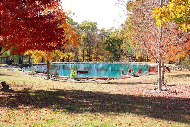 view of swimming pool featuring a water view