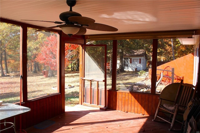 unfurnished sunroom with ceiling fan and plenty of natural light