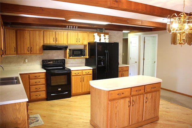 kitchen with hanging light fixtures, backsplash, black appliances, light hardwood / wood-style floors, and sink