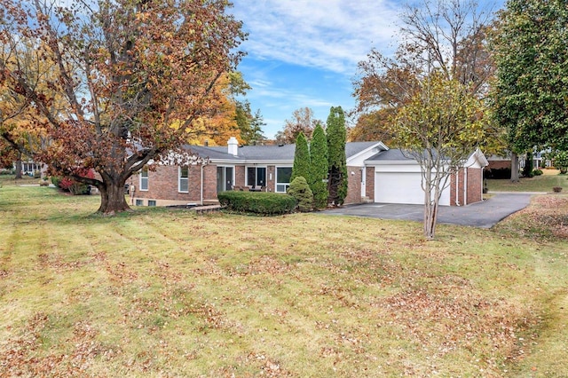 single story home featuring a garage and a front lawn