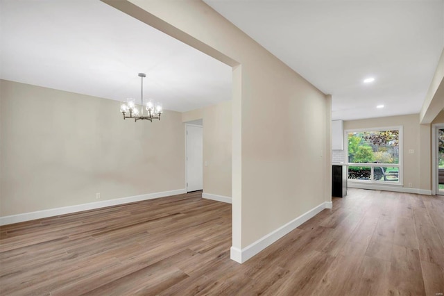 interior space with a chandelier and light hardwood / wood-style flooring