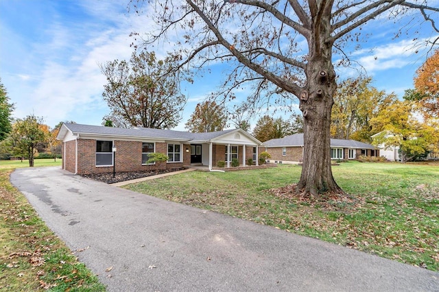 ranch-style home with a front lawn and a sunroom