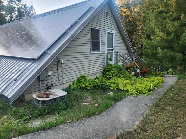 view of side of home with central air condition unit