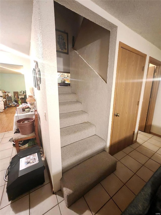 staircase with tile patterned flooring