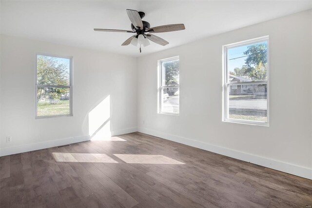 unfurnished room with wood-type flooring, a healthy amount of sunlight, and ceiling fan