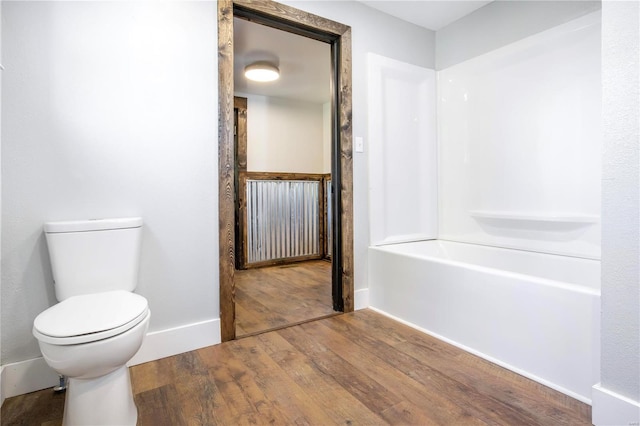 bathroom featuring hardwood / wood-style floors and toilet