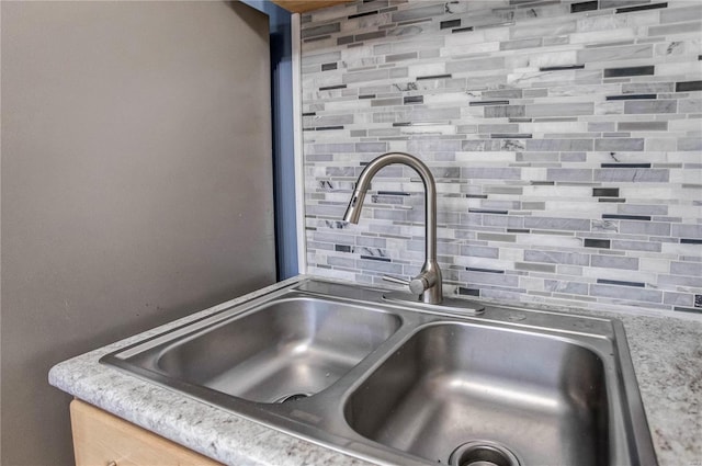 interior details featuring sink and backsplash