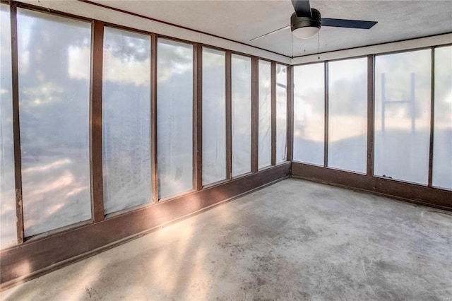 unfurnished sunroom featuring ceiling fan