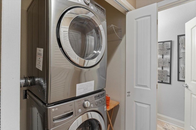 laundry area with stacked washing maching and dryer