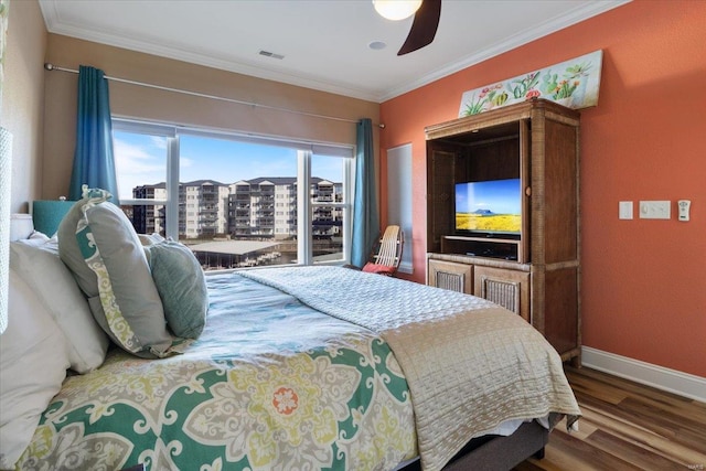 bedroom featuring ceiling fan, dark hardwood / wood-style floors, and ornamental molding