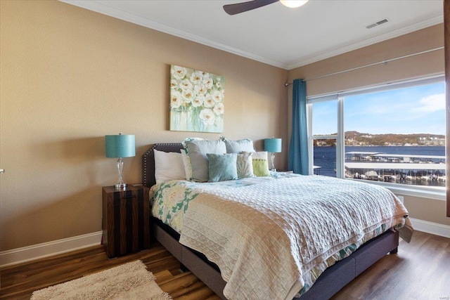 bedroom with ceiling fan, dark hardwood / wood-style floors, and ornamental molding