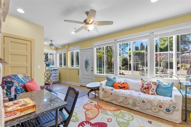 sunroom / solarium featuring ceiling fan