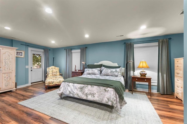 bedroom with dark hardwood / wood-style flooring