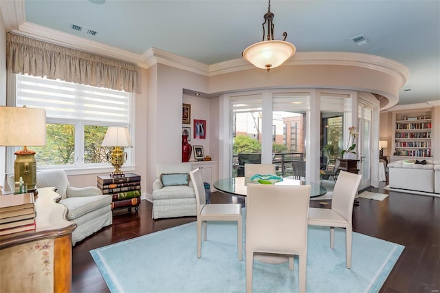 dining room featuring ornamental molding and dark hardwood / wood-style floors