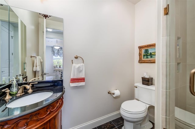 bathroom featuring a shower with door, vanity, toilet, and tile patterned flooring