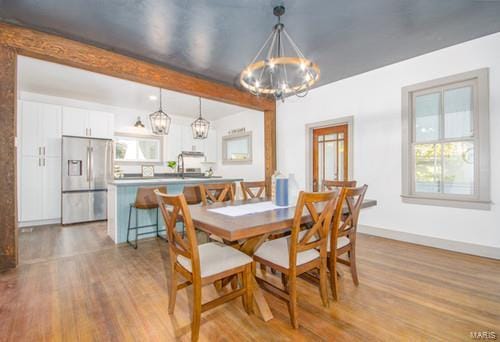 dining space featuring a wealth of natural light and light wood-type flooring