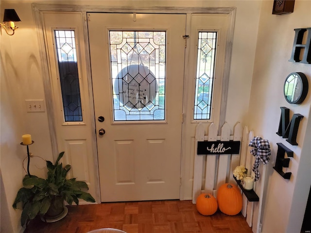 foyer entrance featuring parquet floors