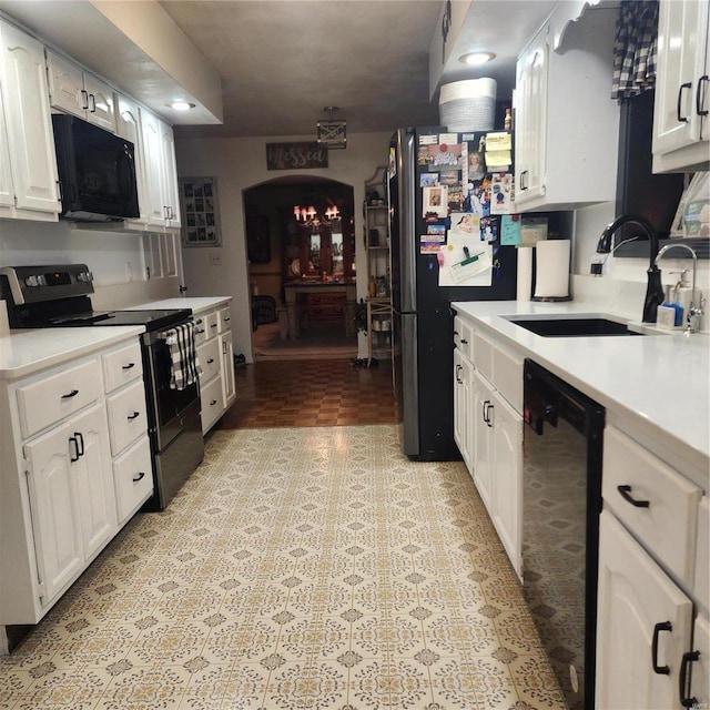 kitchen featuring black appliances, white cabinets, and sink