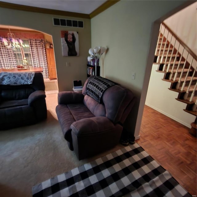 living room featuring a chandelier, parquet floors, and crown molding