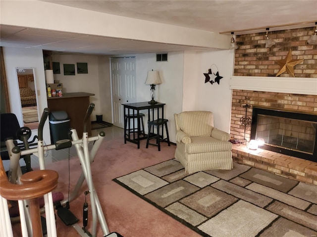 carpeted living room with a brick fireplace