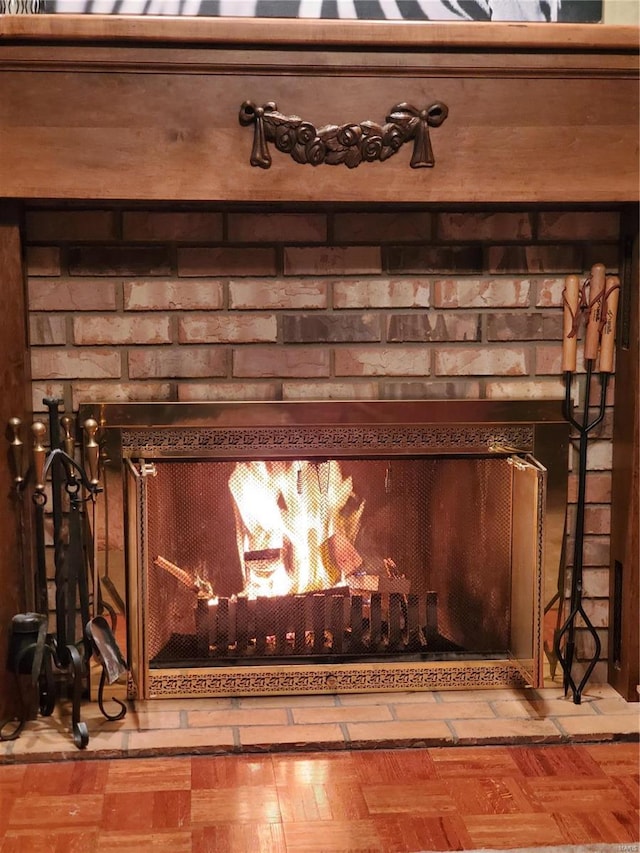 details with parquet floors and a brick fireplace