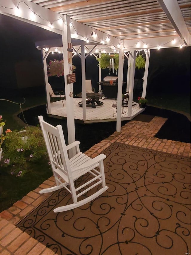 patio at twilight featuring a pergola