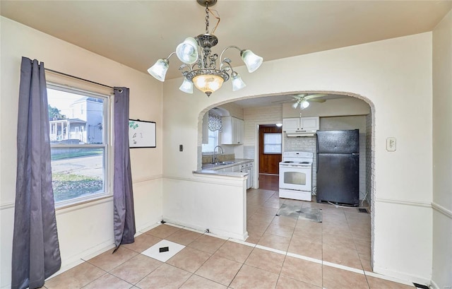 kitchen with black fridge, sink, white electric stove, white cabinetry, and ceiling fan with notable chandelier