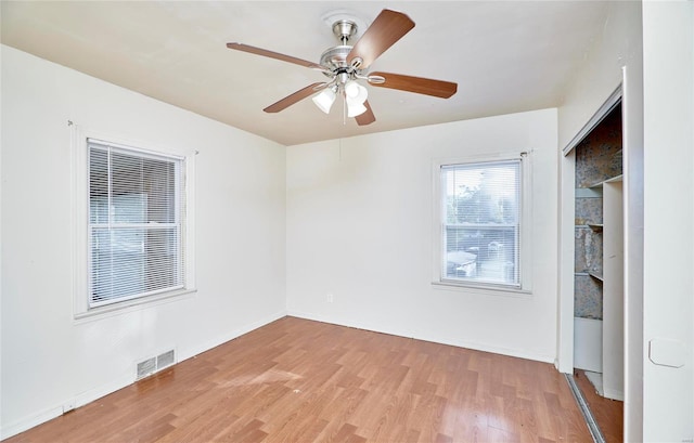 unfurnished room with hardwood / wood-style floors and ceiling fan