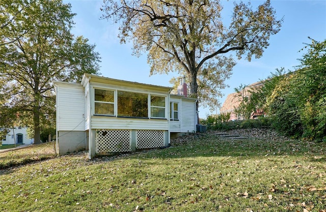 view of home's exterior featuring central AC and a lawn