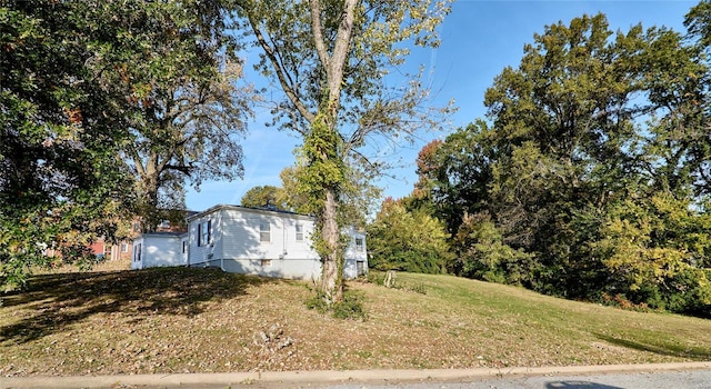 view of side of home featuring a lawn