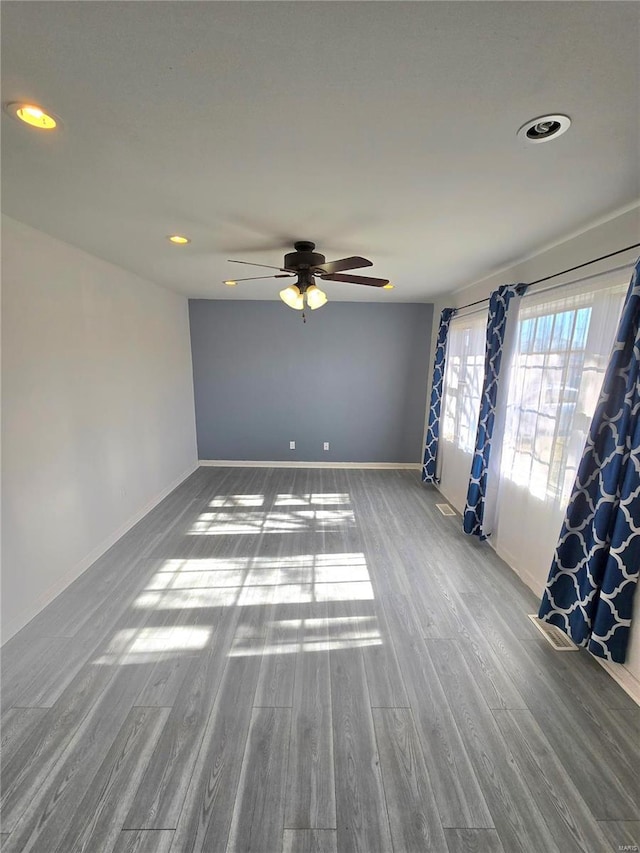 spare room with recessed lighting, baseboards, wood finished floors, and a ceiling fan