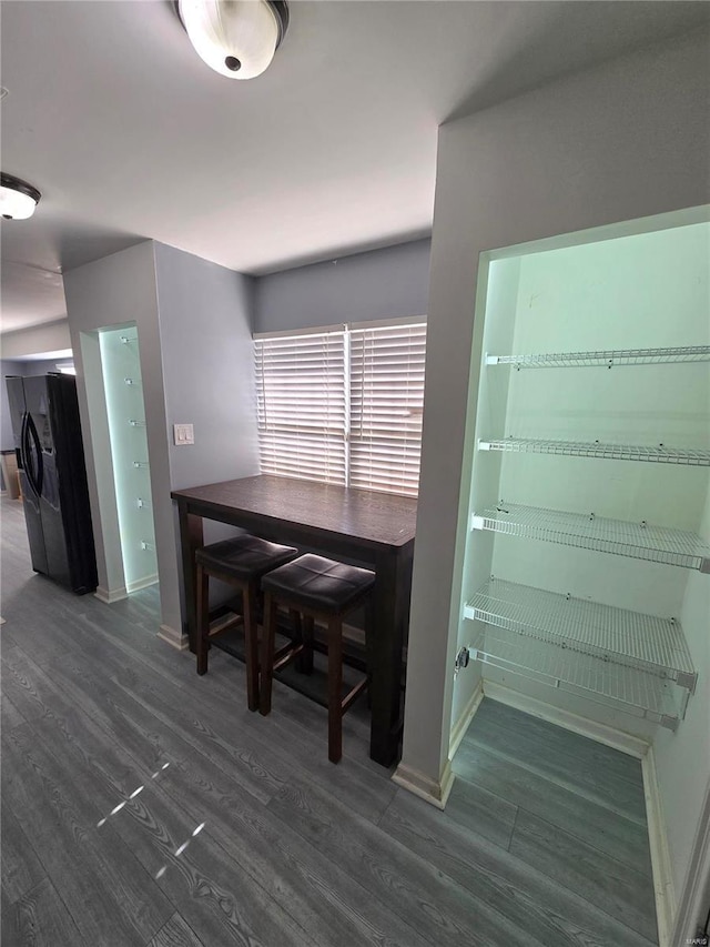 dining area with baseboards and wood finished floors