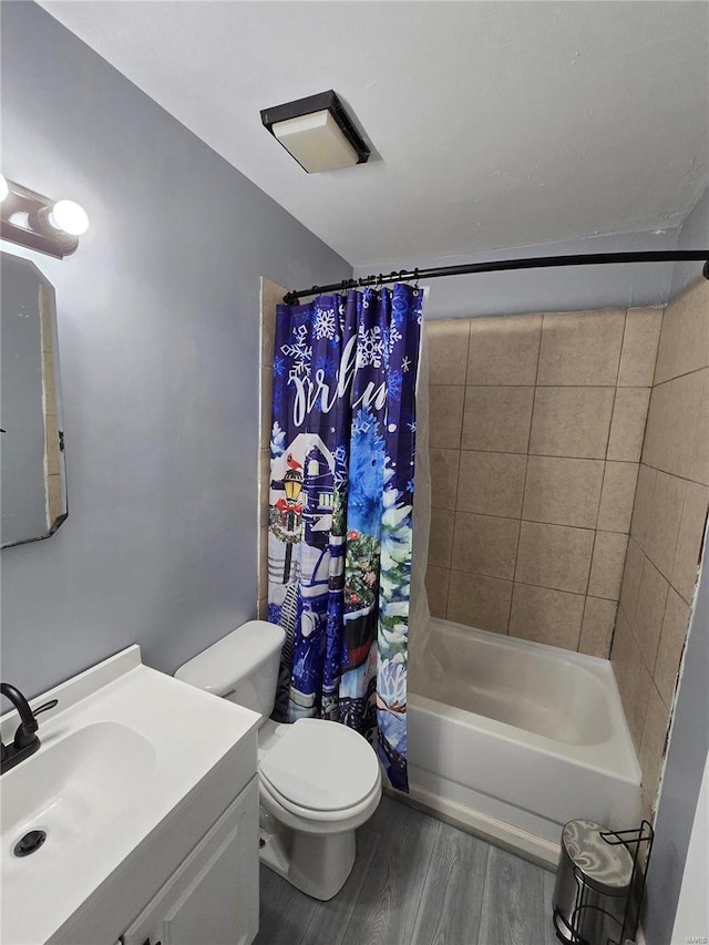 bathroom featuring shower / bath combination with curtain, toilet, vanity, and wood finished floors