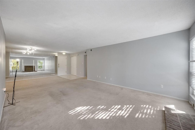 carpeted spare room featuring a textured ceiling