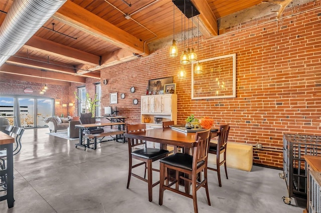 dining room featuring beam ceiling, brick wall, and wooden ceiling