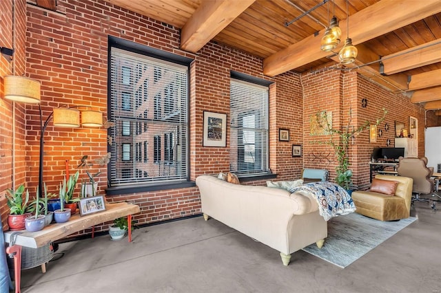 living room featuring wood ceiling, beam ceiling, and brick wall