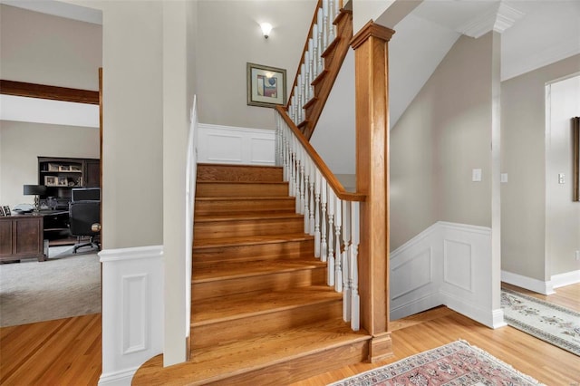 stairway featuring decorative columns and hardwood / wood-style floors