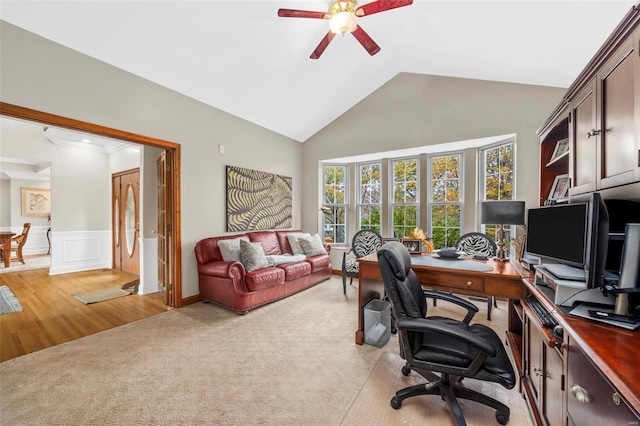 home office with light hardwood / wood-style floors, high vaulted ceiling, and ceiling fan