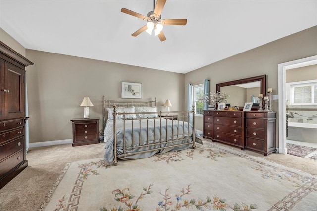 carpeted bedroom featuring ensuite bathroom and ceiling fan