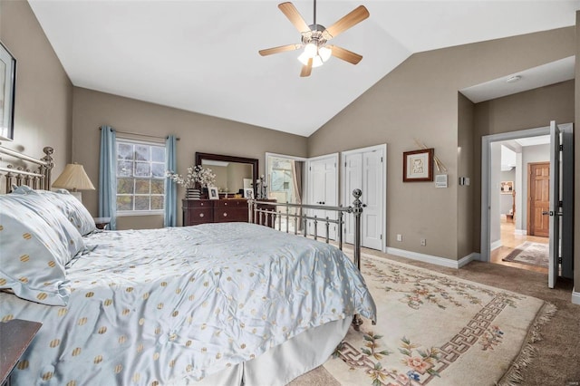 carpeted bedroom with ceiling fan and vaulted ceiling