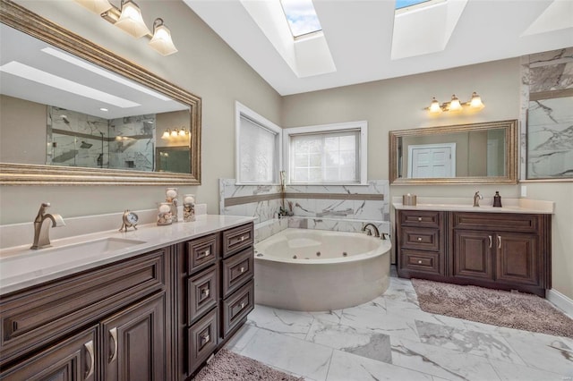 bathroom featuring vanity, shower with separate bathtub, and a skylight