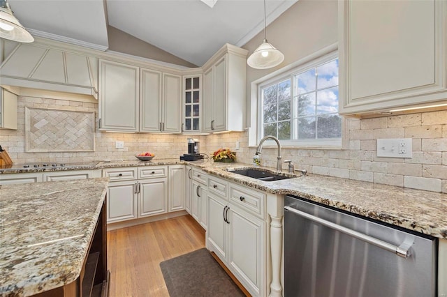 kitchen with sink, hanging light fixtures, stainless steel dishwasher, tasteful backsplash, and stovetop