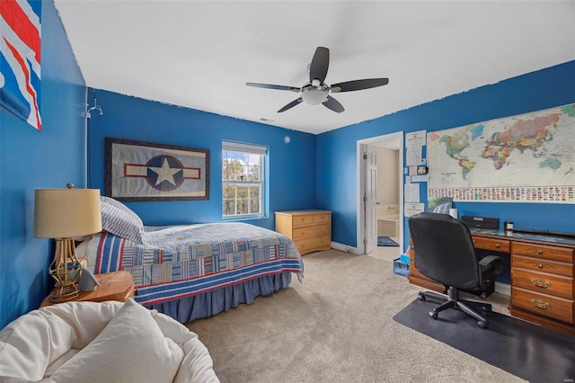 bedroom featuring ceiling fan, light colored carpet, and ensuite bathroom