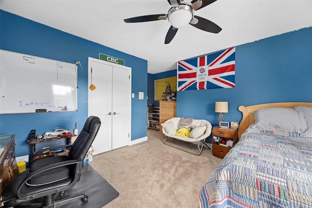 bedroom with a closet, light colored carpet, and ceiling fan