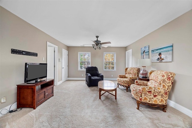 carpeted living room featuring ceiling fan