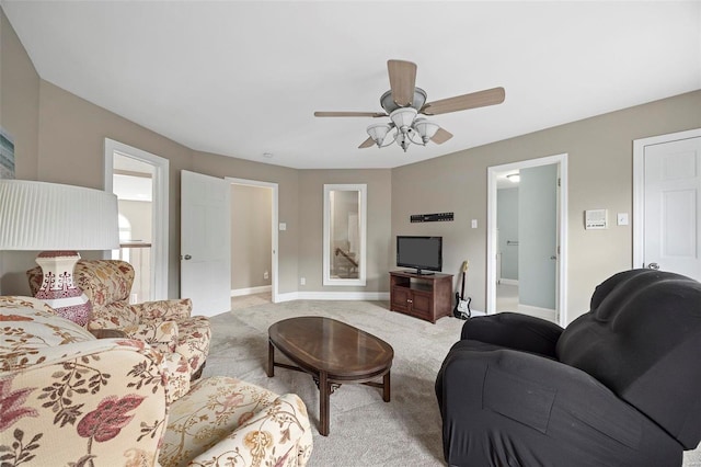 carpeted living room with ceiling fan