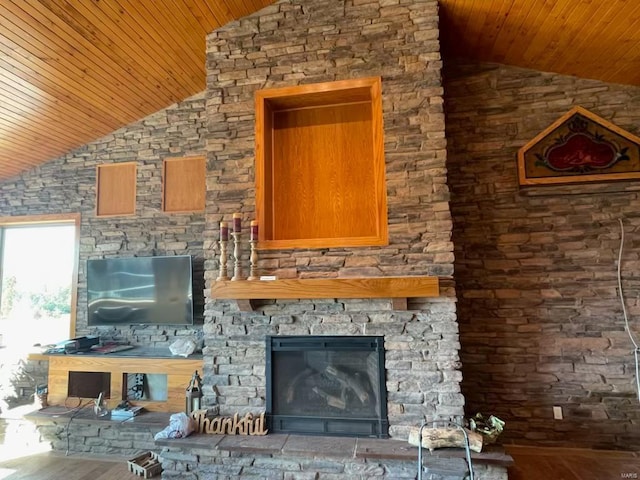 unfurnished living room featuring vaulted ceiling, wood ceiling, a fireplace, and hardwood / wood-style flooring