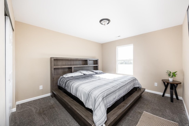 bedroom featuring carpet floors and baseboards